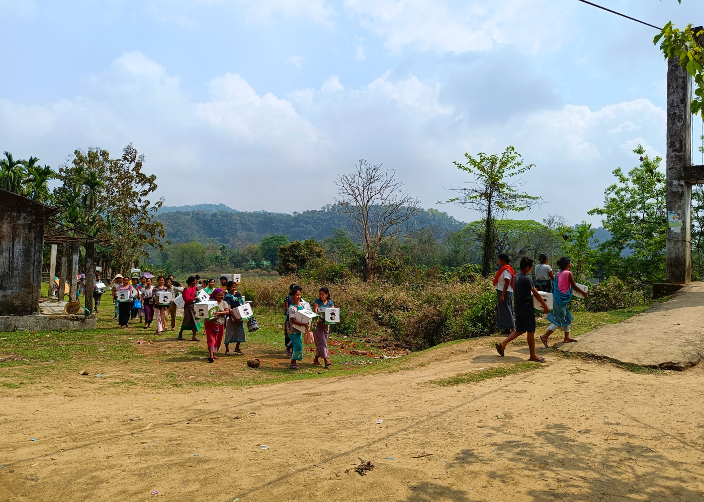 Villagers carrying clean cookstoves to their households