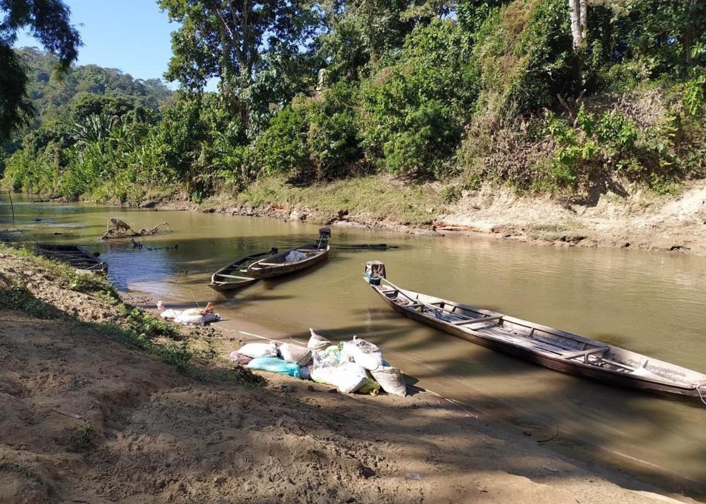 Boats anchored along the riverbank, the only link to remote villages in Northeast India without road access